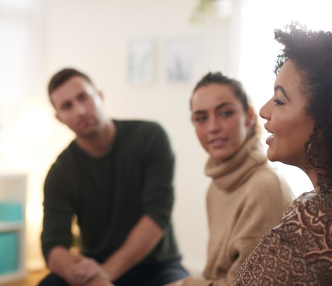 Woman talking to group of people